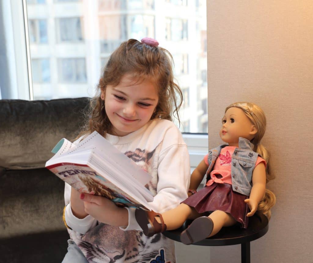 Girl reading to her doll