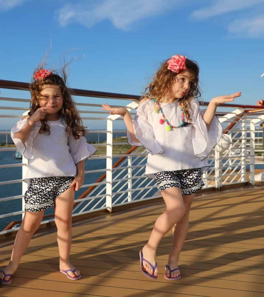 Two girls modeling Mia Belle Baby clothes for girls