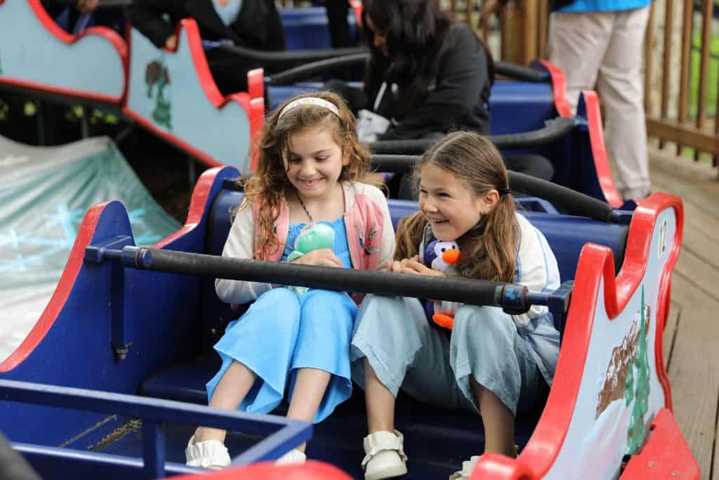 Girls holding amusement park prizes 