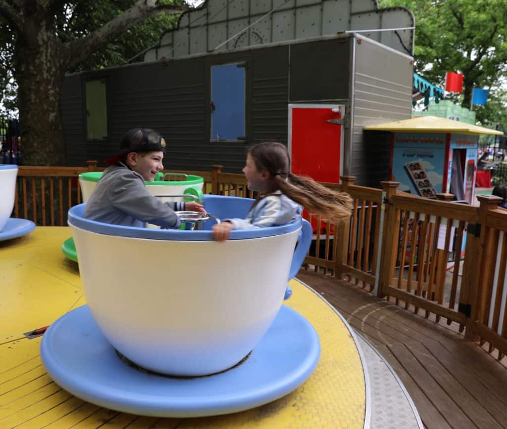 Kids spinning in amusement park teacups