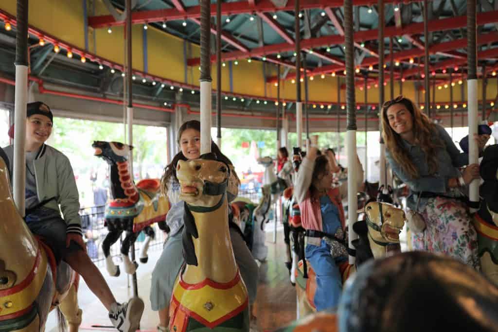 Family enjoying Fantasy Forest amusement park carrousel