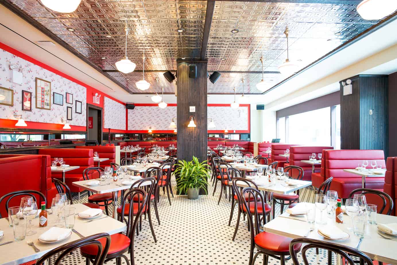Parm restaurant interior with red leather booth seating and several four-top tables