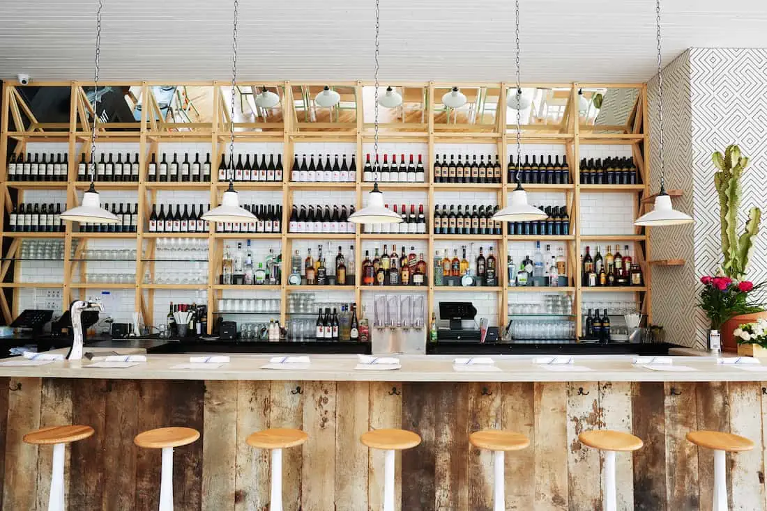 NYC Seamore's wooden rustic aesthetic bar with bright lighting 