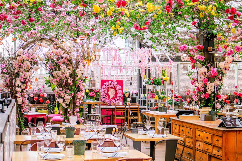 SERRA rooftop by Birreria in New York City with large pink floral arrangements 