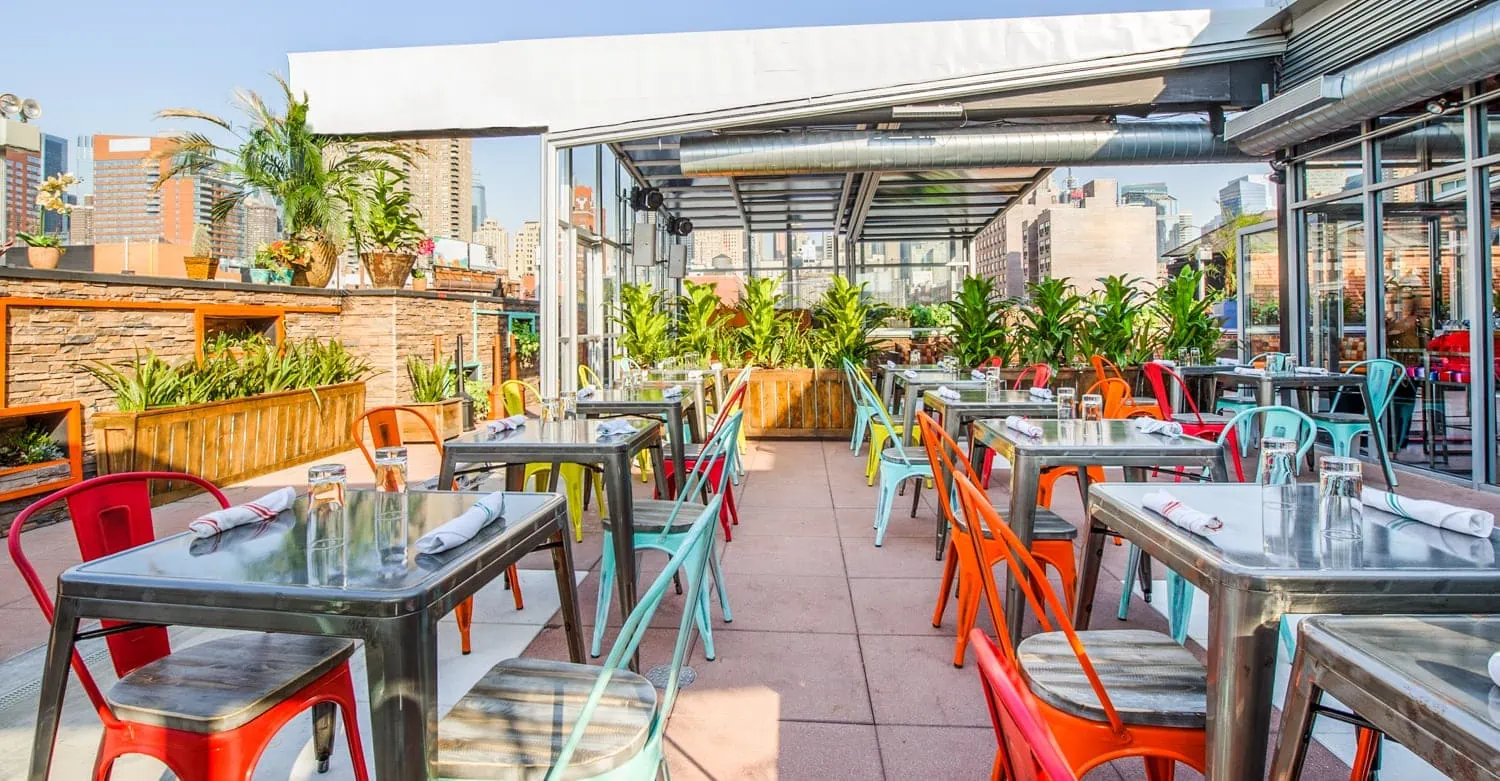Cantina outdoor rooftop restaurant in New York City with colorful chairs 