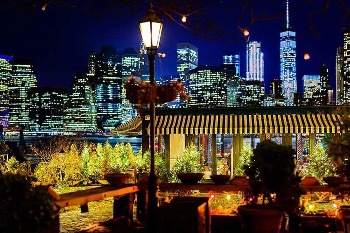 Brooklyn River Cafe rooftop in nighttime with NYC in background