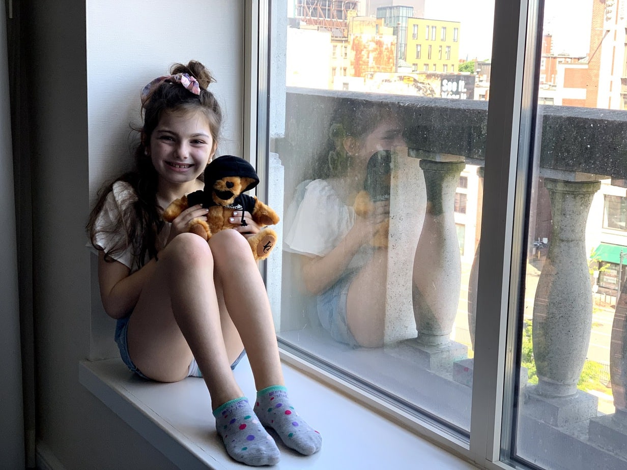 Child in window seat of Hotel Commonwealth room