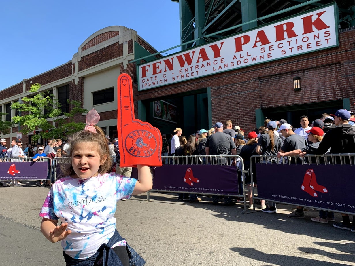 Young fan cheering at Fenway Park