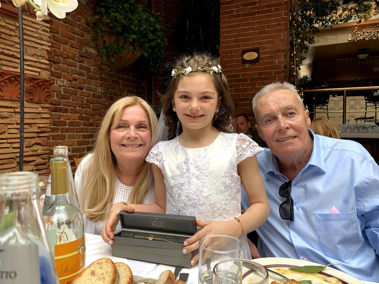 Girl with grandparents at First Holy Communion party