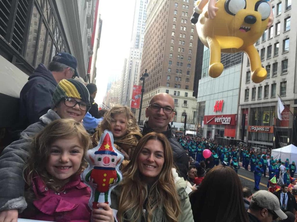 Family watching the Macy's parade during a Thanksgiving weekend In NYC