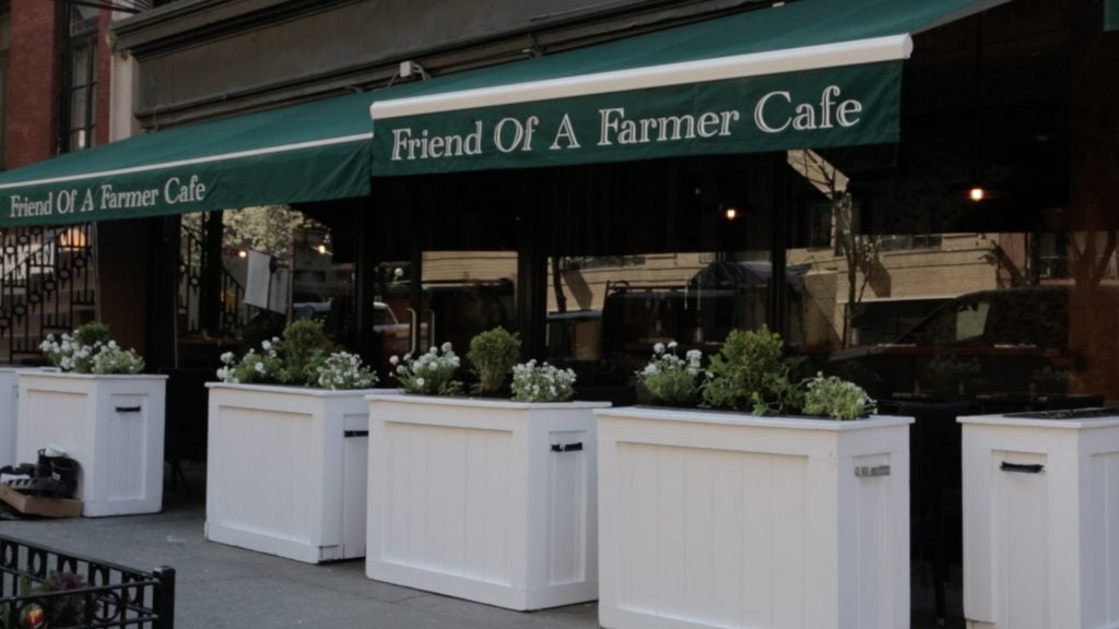 Best fall restaurant for brunch Friend of a Farmer's green awning exterior with flower bins underneath windows 