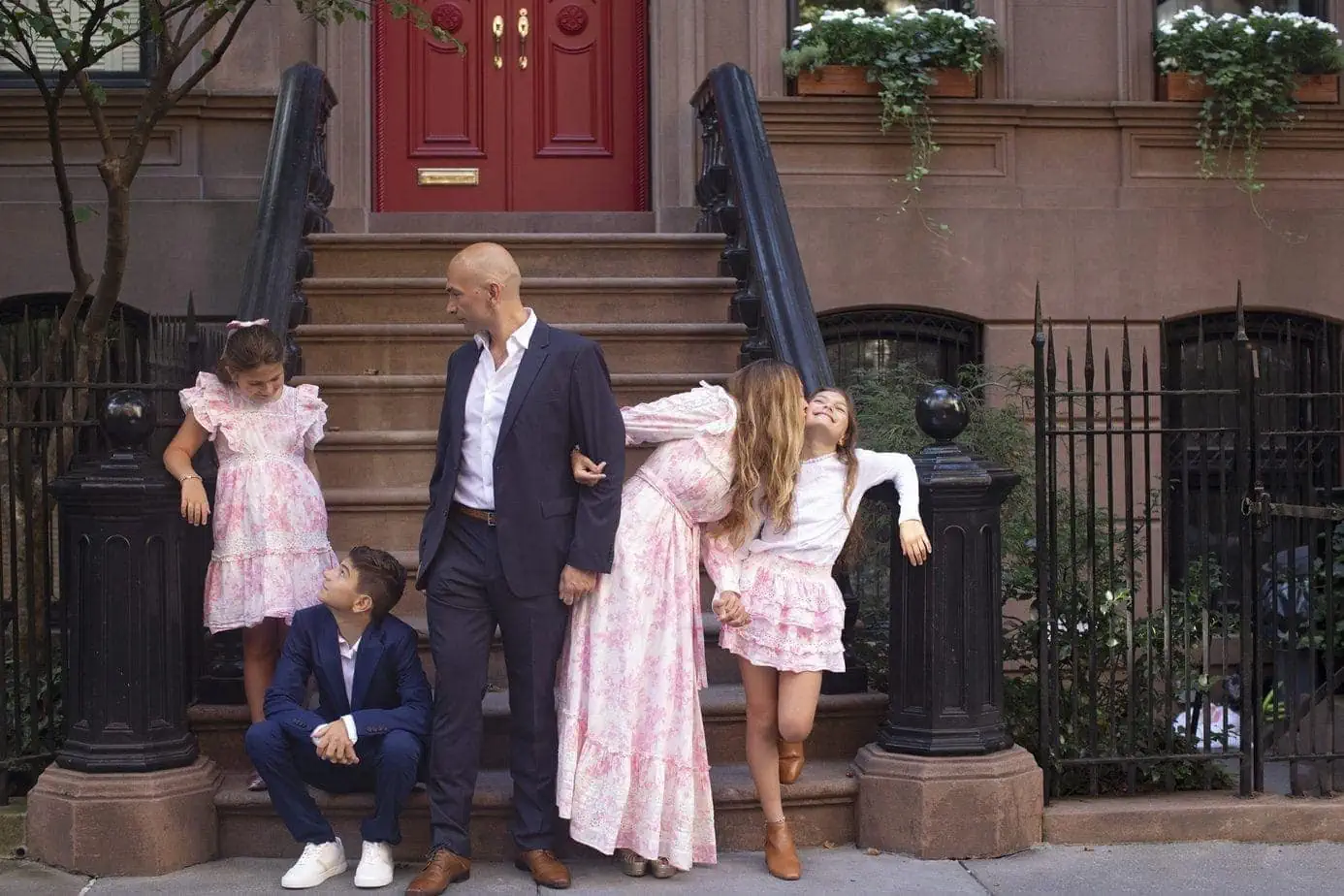 Family photoshoot outside of NYC brownstone in matching outfits