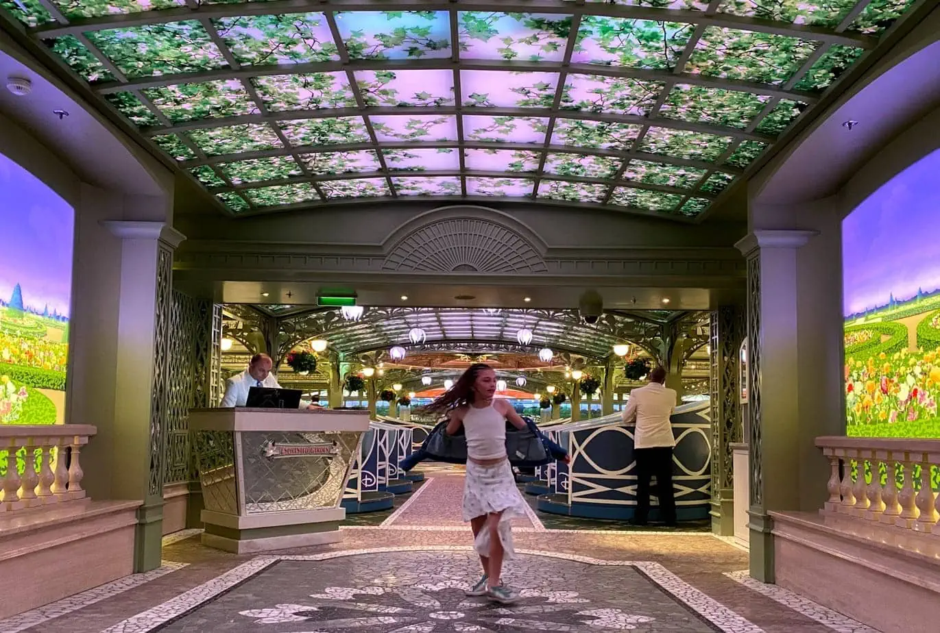 Daughter dancing in front of Enchanted Garden restaurant decorated with Green flights 