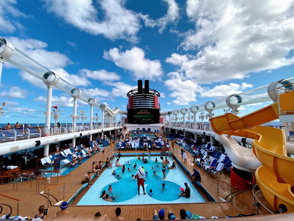 Disney cruise main deck's Mickey Mouse shaped pool packed with people