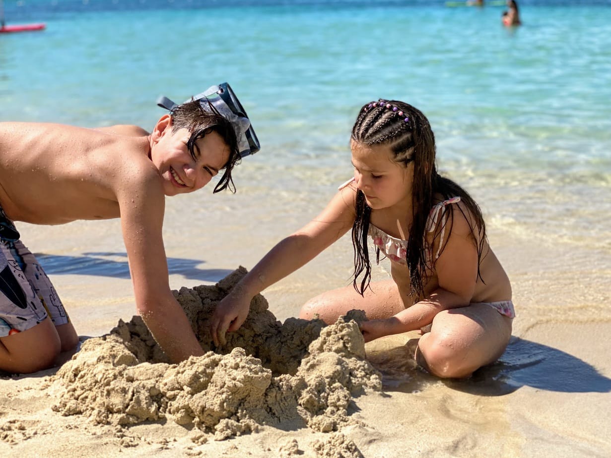 Daughter and son playing in sand at St. Thomas beach