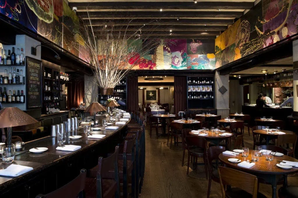Interior of NYC's Gramercy Tavern with dim light and colorful ceiling art