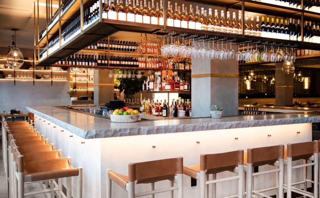 NYC best fall restaurants Malinu farm with modern aesthetic bar of white and wood accents