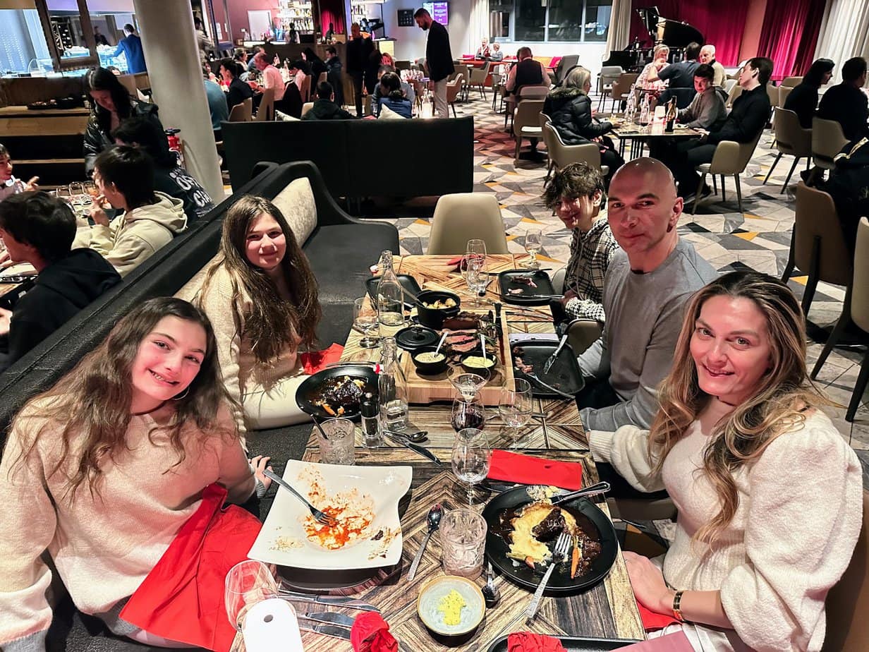 Family enjoying dinner at a cozy restaurant in Club Med La Rosière