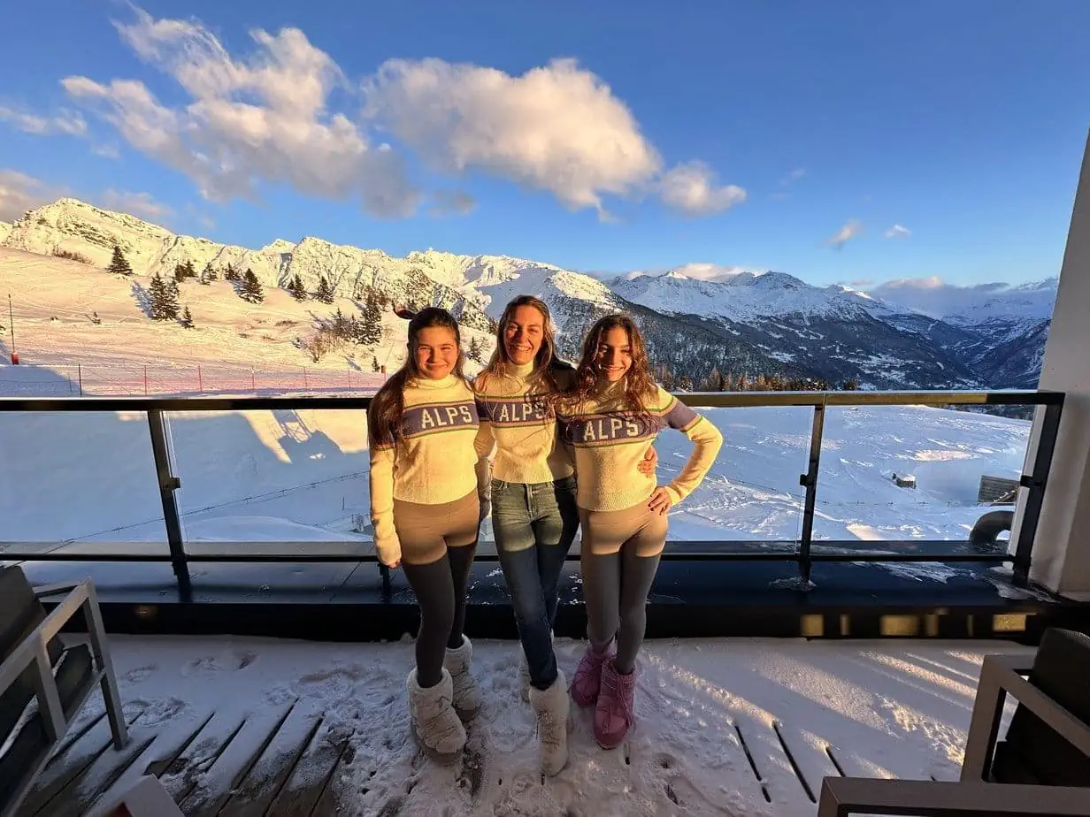 Mother-daughter matching "Alps" sweaters while on ski vacation in French Alps