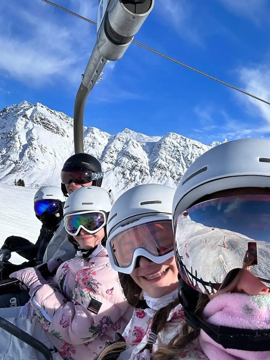 Family selfie on ski lift at French alps ski resort 