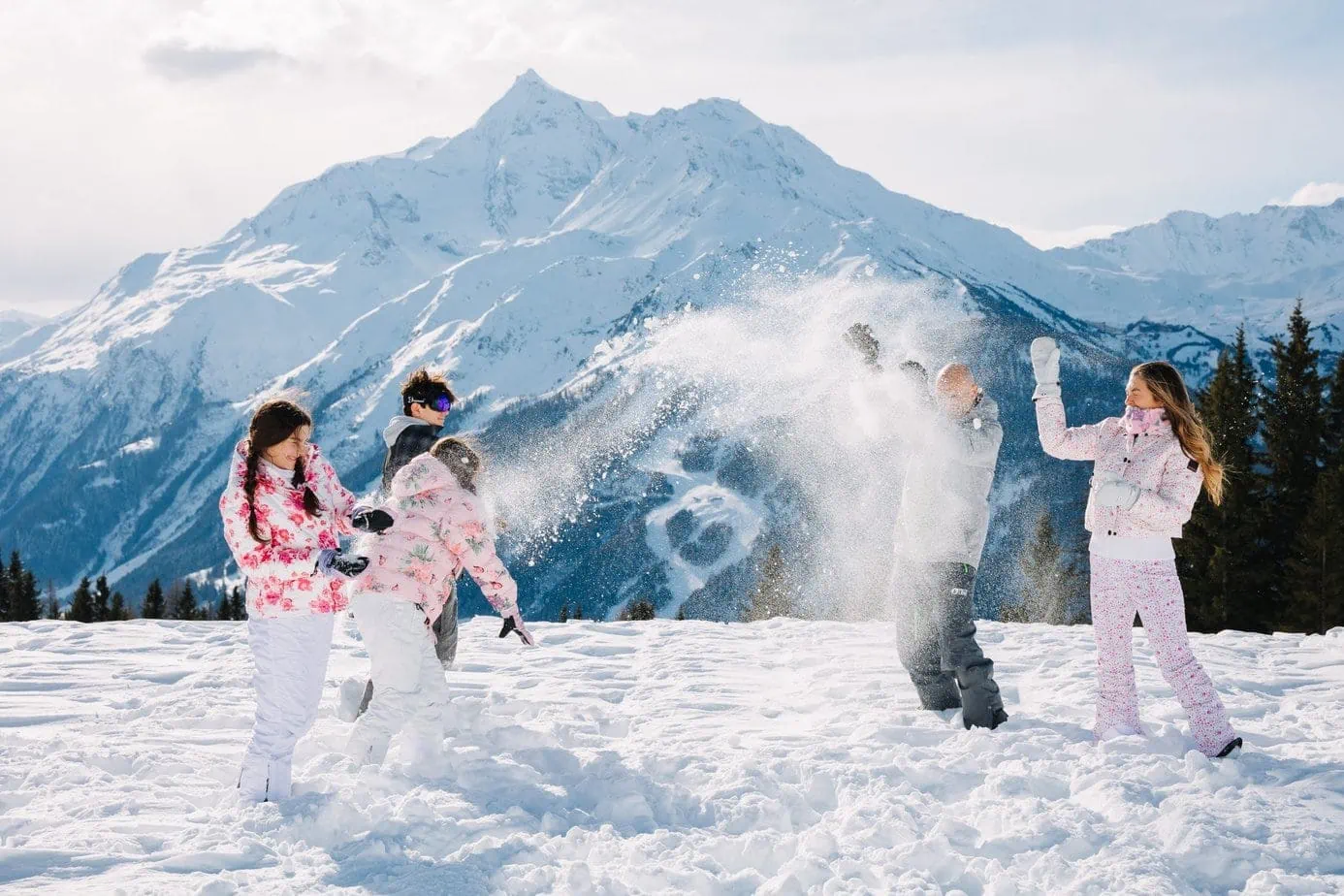 Family snow fight on French Alp mountains