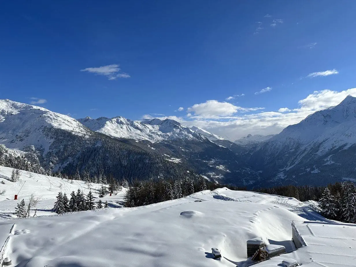 View while skiing of snowy French Alps mountain range