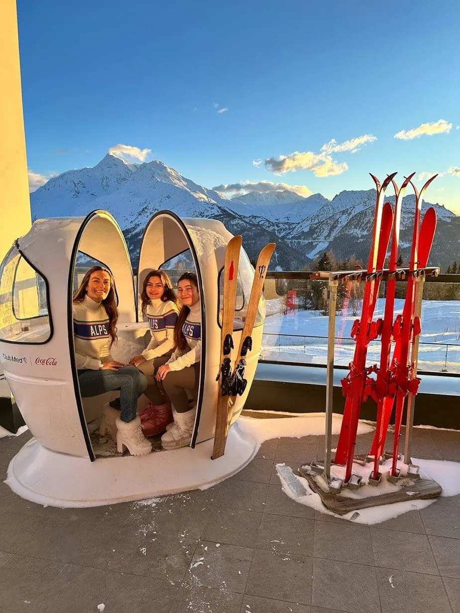 Kids posing in is lift photo-ops wearing matching "Alps" sweaters