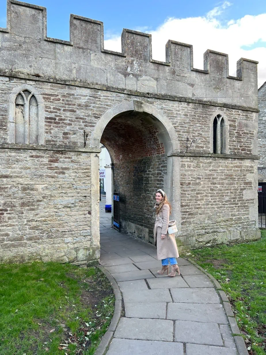 Brianne walking underneath stone arch found in Cotswolds villages