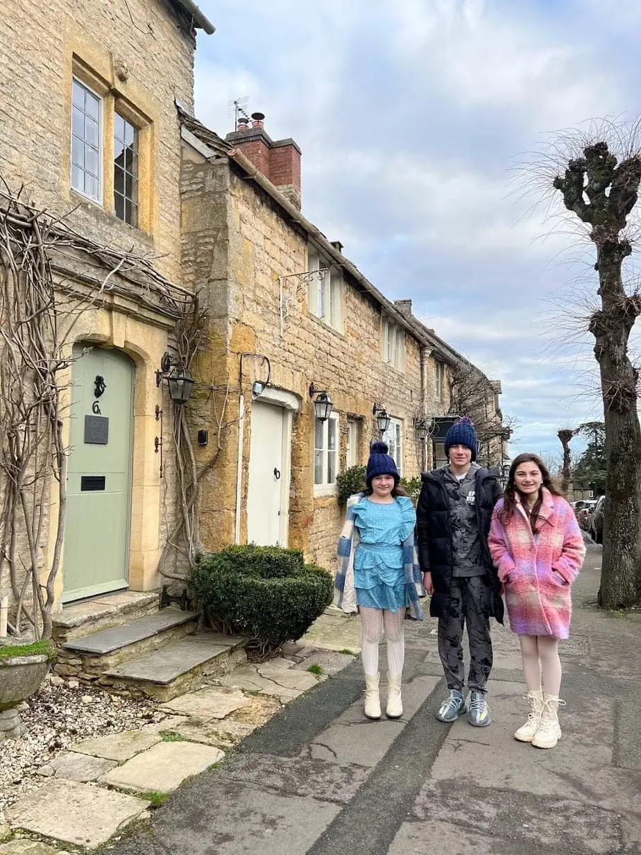 Family exploring the tiny, stone villages in Cotswolds