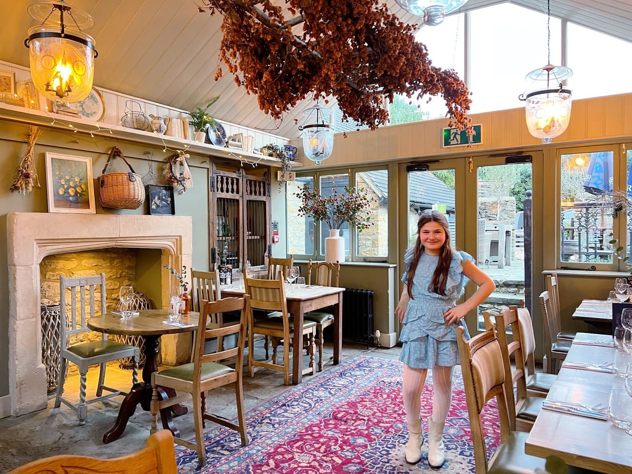 Daughter in cozy, English countryside restaurant