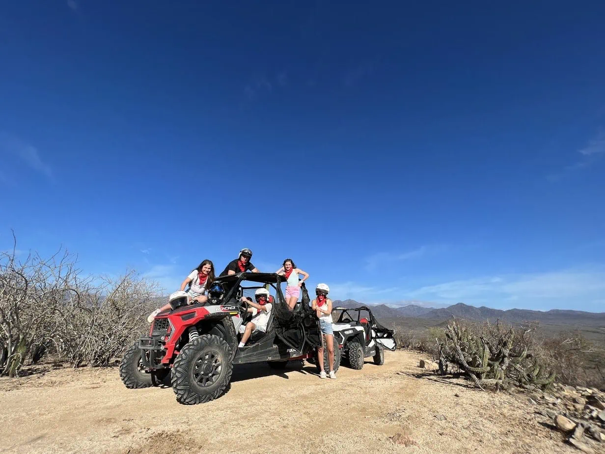 Family posing on ATV in Cabo desert