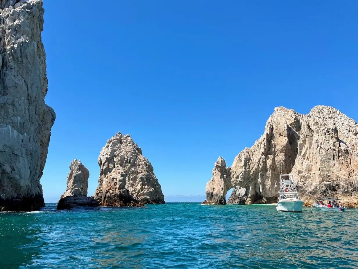 The rocky beach of Los Cabos with bright blue sea water