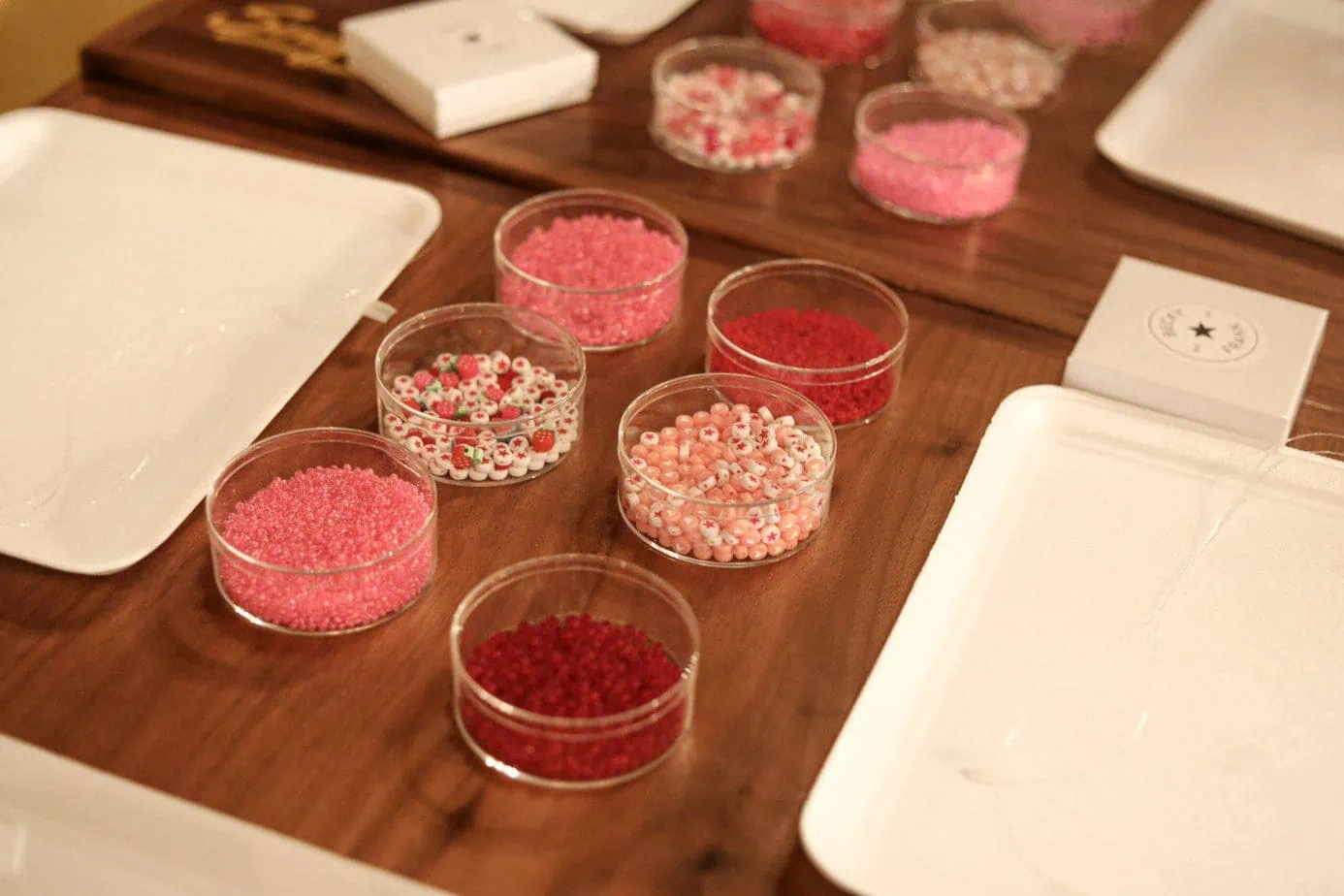 Pink beads organized on table for birthday party designs