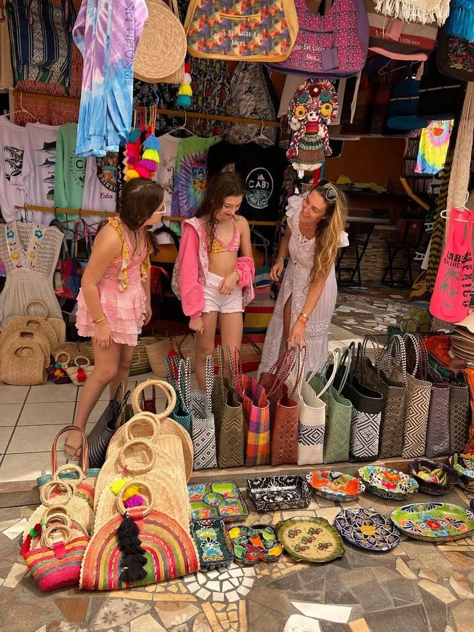 Family exploring colorful marketplace in Cabo
