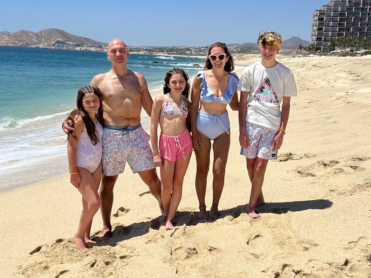 Family on sunny beach on vacation in Cabo, Mexico