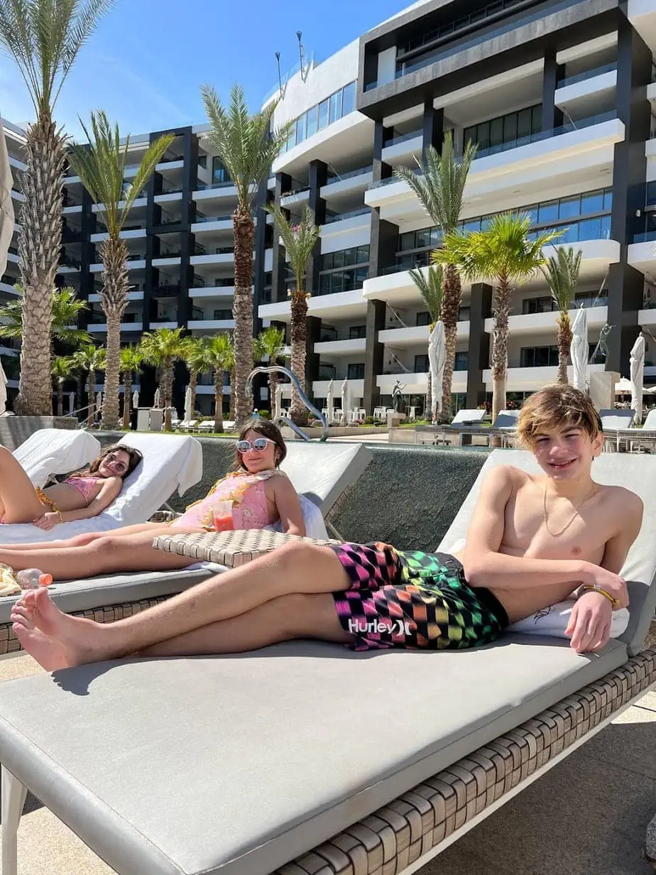 Kids lounging poolside at Cabos hotel