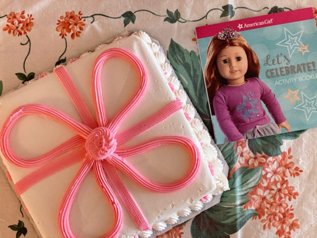 American Girl Doll birthday cake with large pink frosting bow