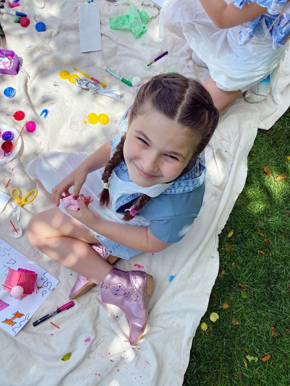 Smiling daughter at birthday party in NYC where they paint in the park