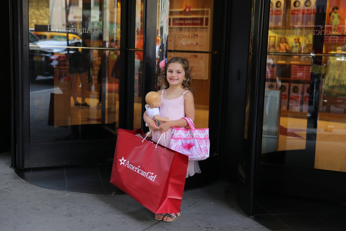 Daughter outside the NYC American Girl Doll store with a new doll 