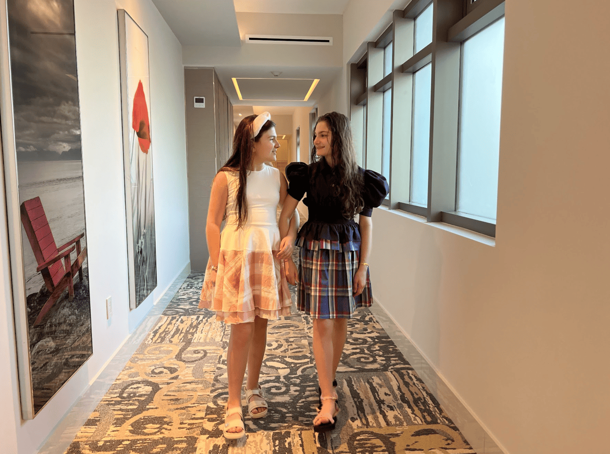 Daughters wearing dresses with pink and blue plaid skirts