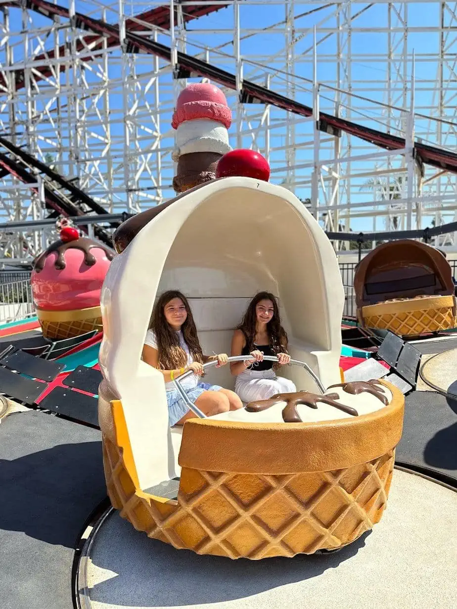 Kids enjoying teacup spin amusement park ride