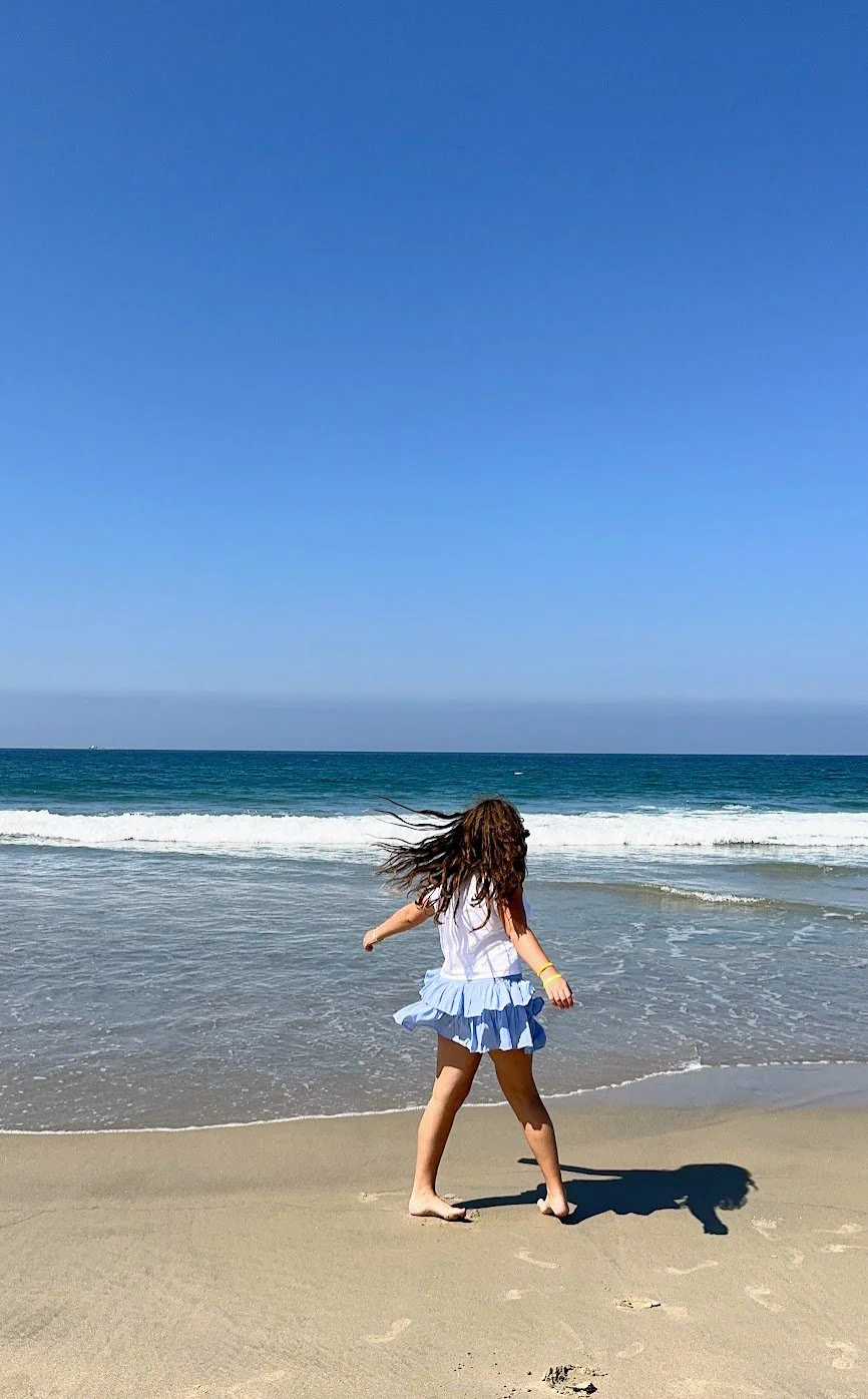 Daughter playing on beach in San Diego