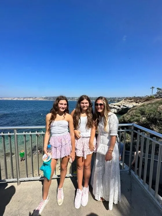 Mother and daughters enjoying beach view in San Diego